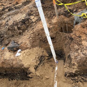 3” pipe in already excavated trench and bed in sand